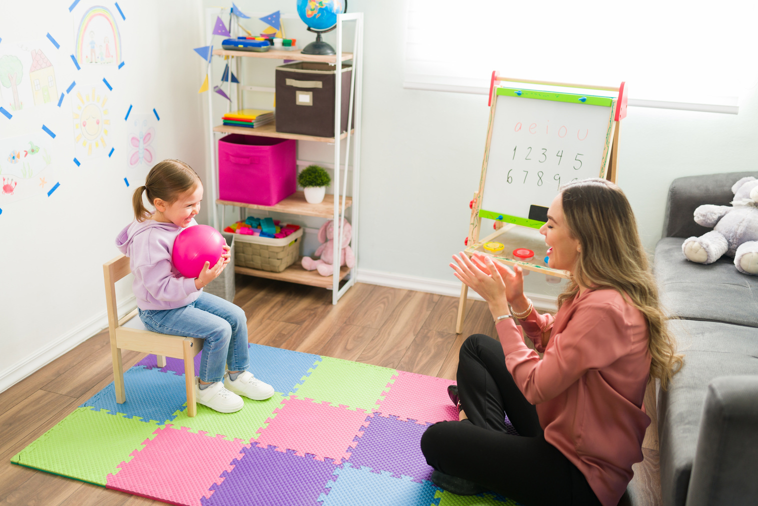 Happy psychologist having a therapy session with a child