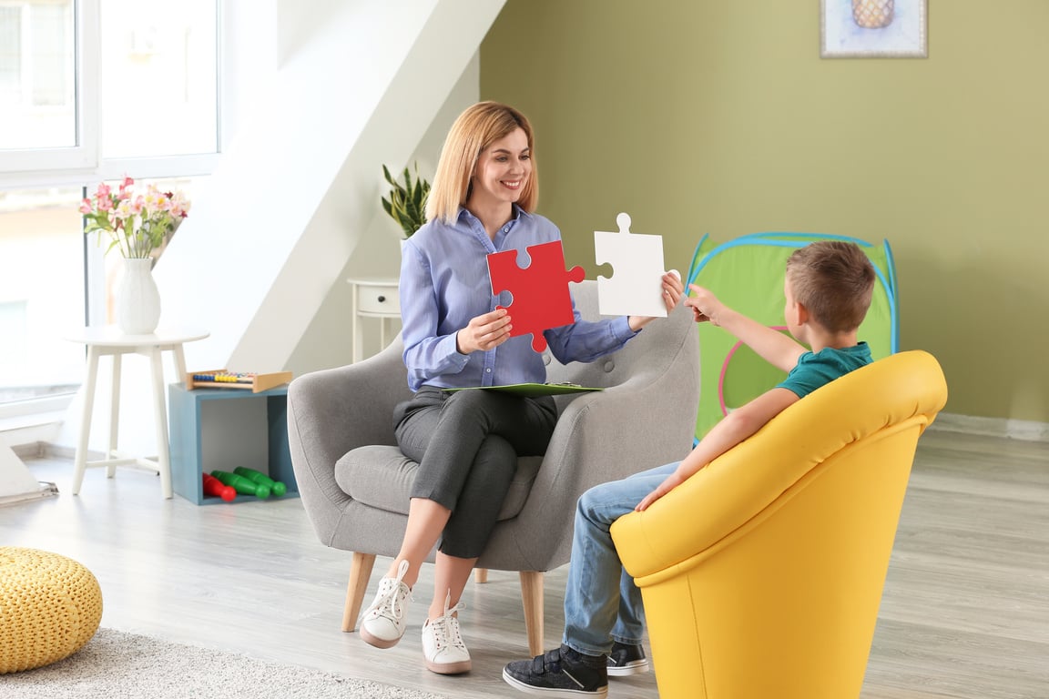 Female Psychologist Playing with a Boy 